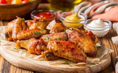 Plate of Barbecue Chicken Wings with various Dips