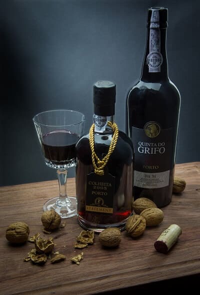 Two Bottles of Port Wine and Glass filled with Wine