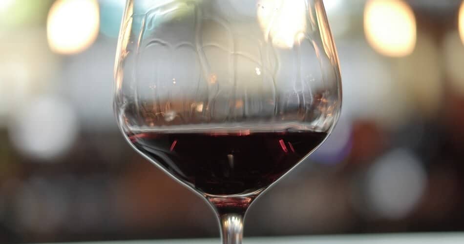 Close Up of Red Wine Glass Containing a Red Wine with Full Wine Body that Creates Wine Legs