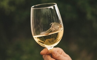 Man Swirling Glass to Encourage the Odors of Alcohol in Wine to Evaporate